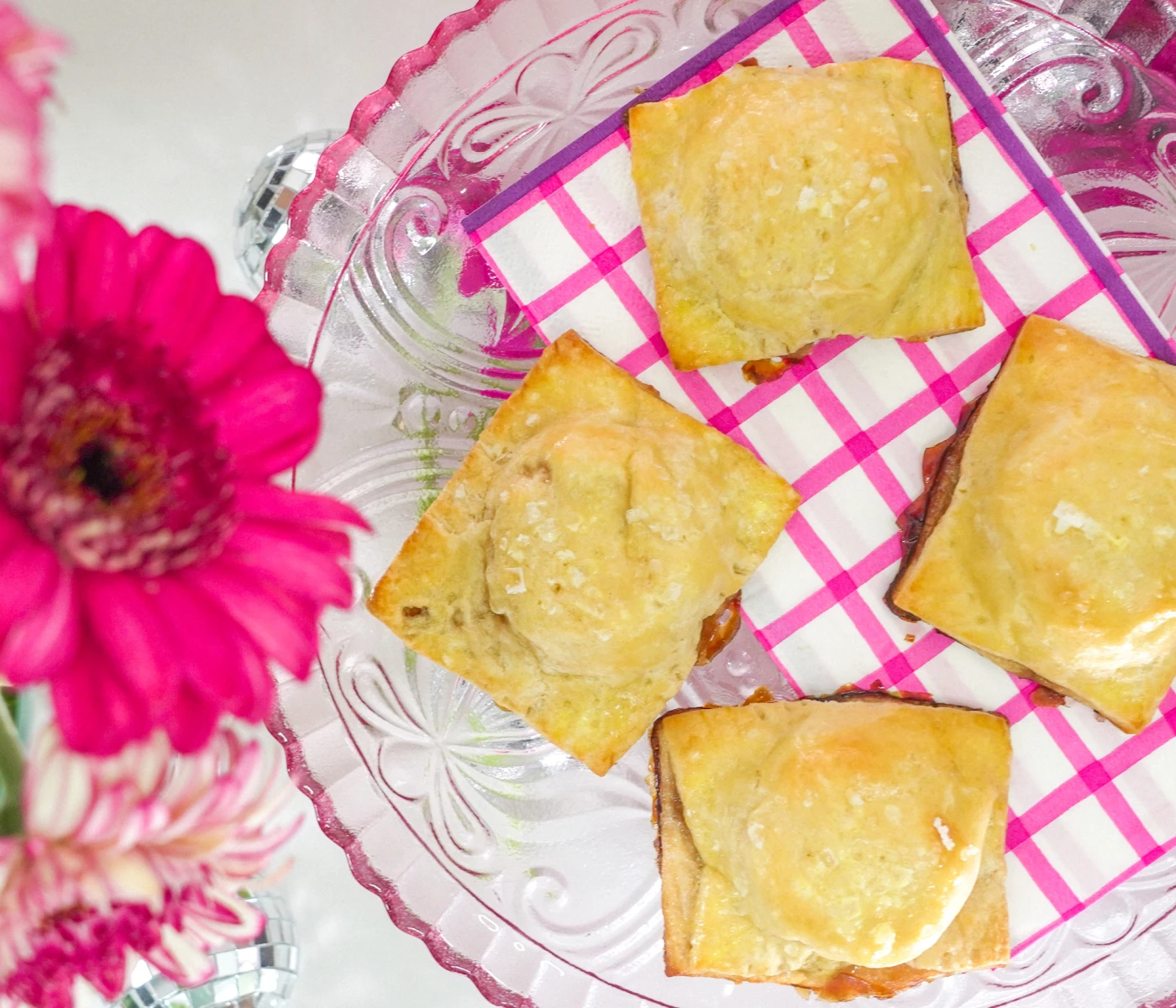 Baked brie bites on a pink plate.