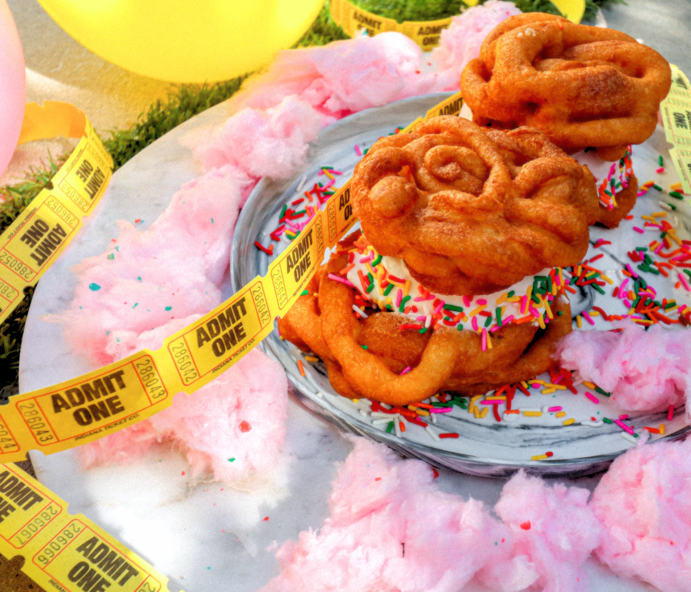 Funnel cake ice cream sandwiches with cotton candy and carnival tickets.