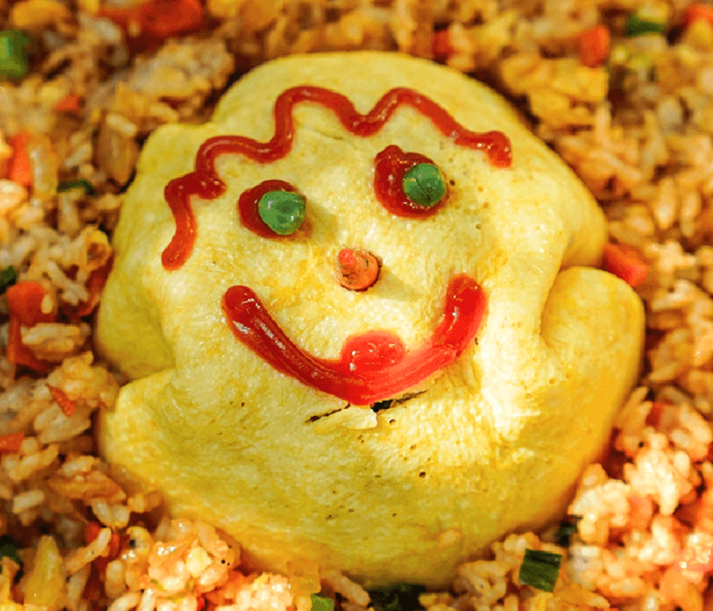 Omurice with ketchup decorated in a smiley face.