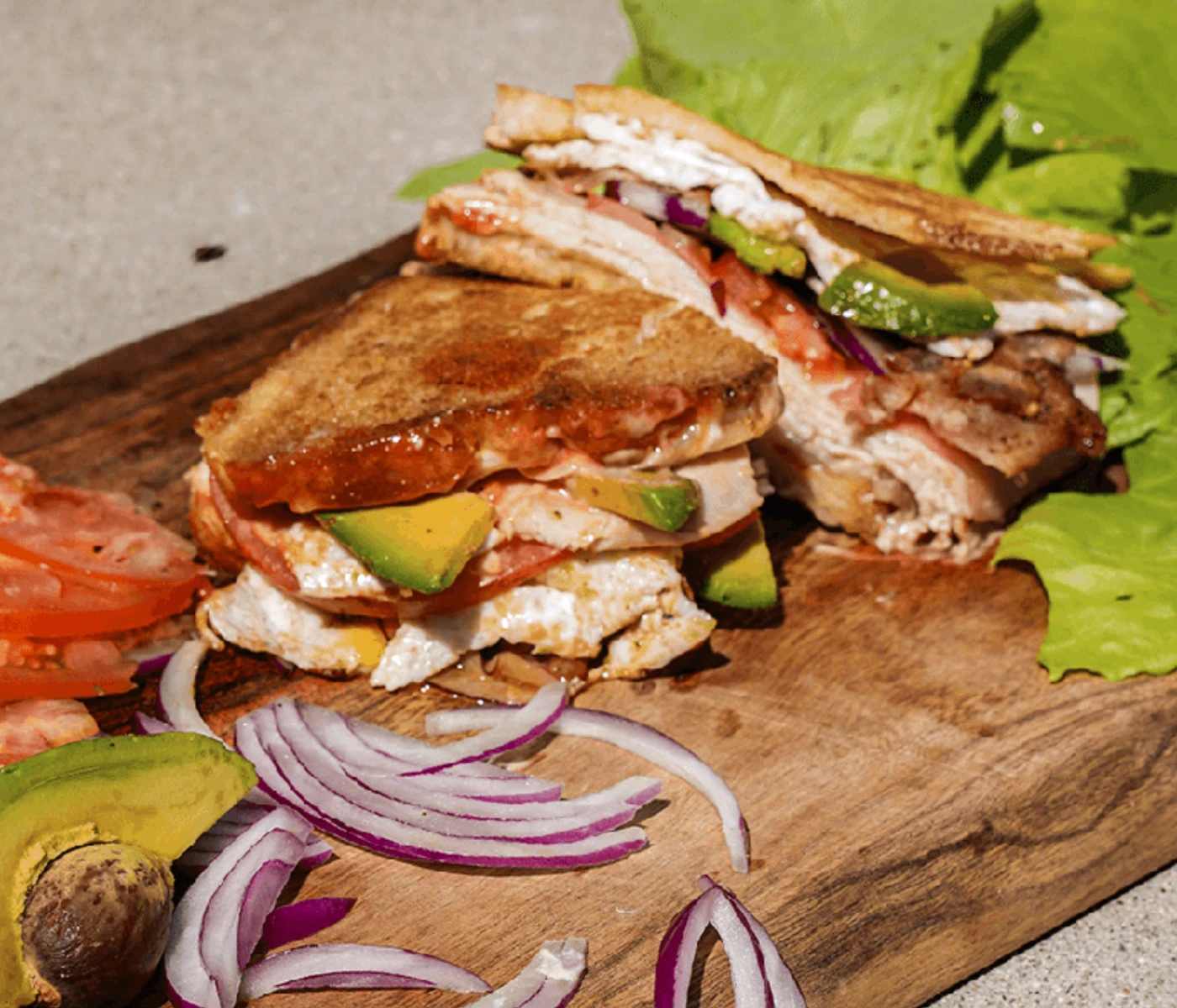 Classic sandwich with turkey, avocado, tomato and red onions.